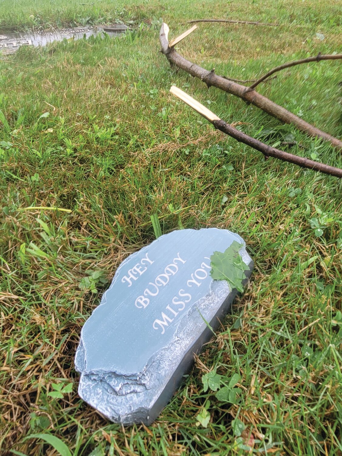 MEMENTOS SCATTERED: The tiny memories and tokens of affection that loved ones have left on the graves of family and friends were scattered across the burial grounds at Highland Memorial Park Cemetery in Johnston during Friday’s severe storm.